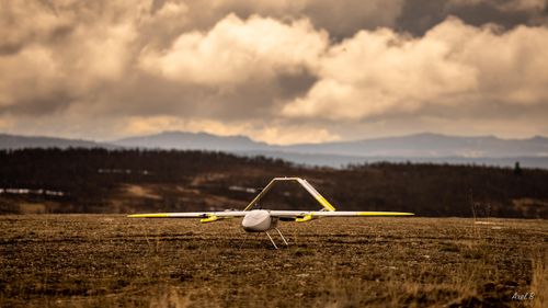An image of a drone on the ground, ready to take off