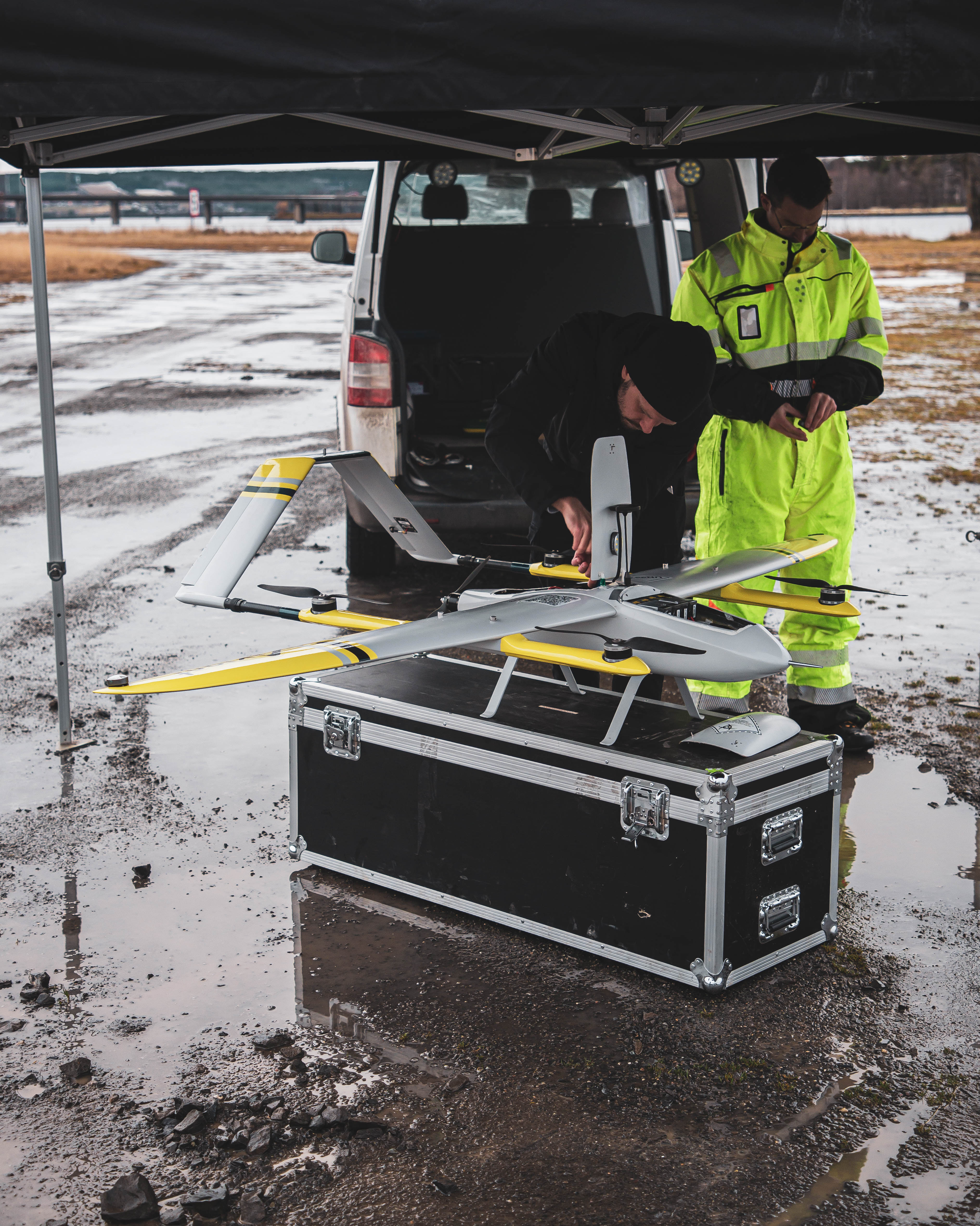 An image of a drone and two operators doing maintenance
